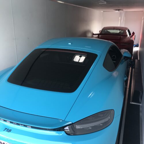 Two Sports cars inside a truck